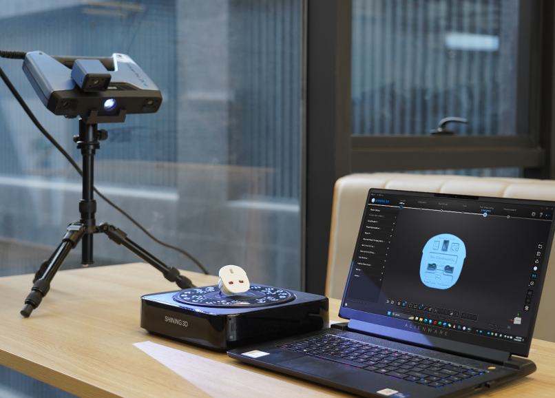 EinScan Pro 2X V2 set up on a tripod with a turntable and laptop displaying a precise 3D scan.