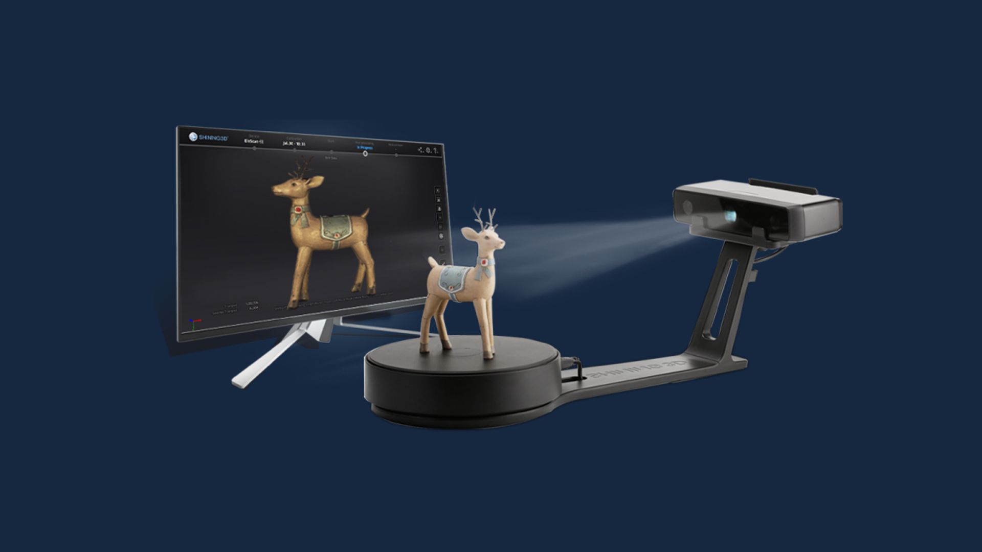 A 3D deer figurine being scanned on the EinScan SE V2 automated turntable with the 3D result shown on a connected monitor.
