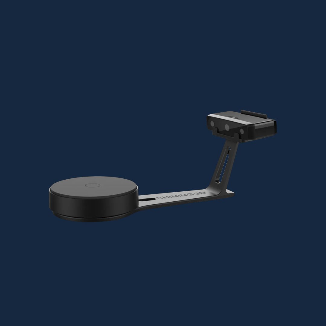 A studio product render of the EinScan SE V2 scanner and automated turntable on a dark blue background.