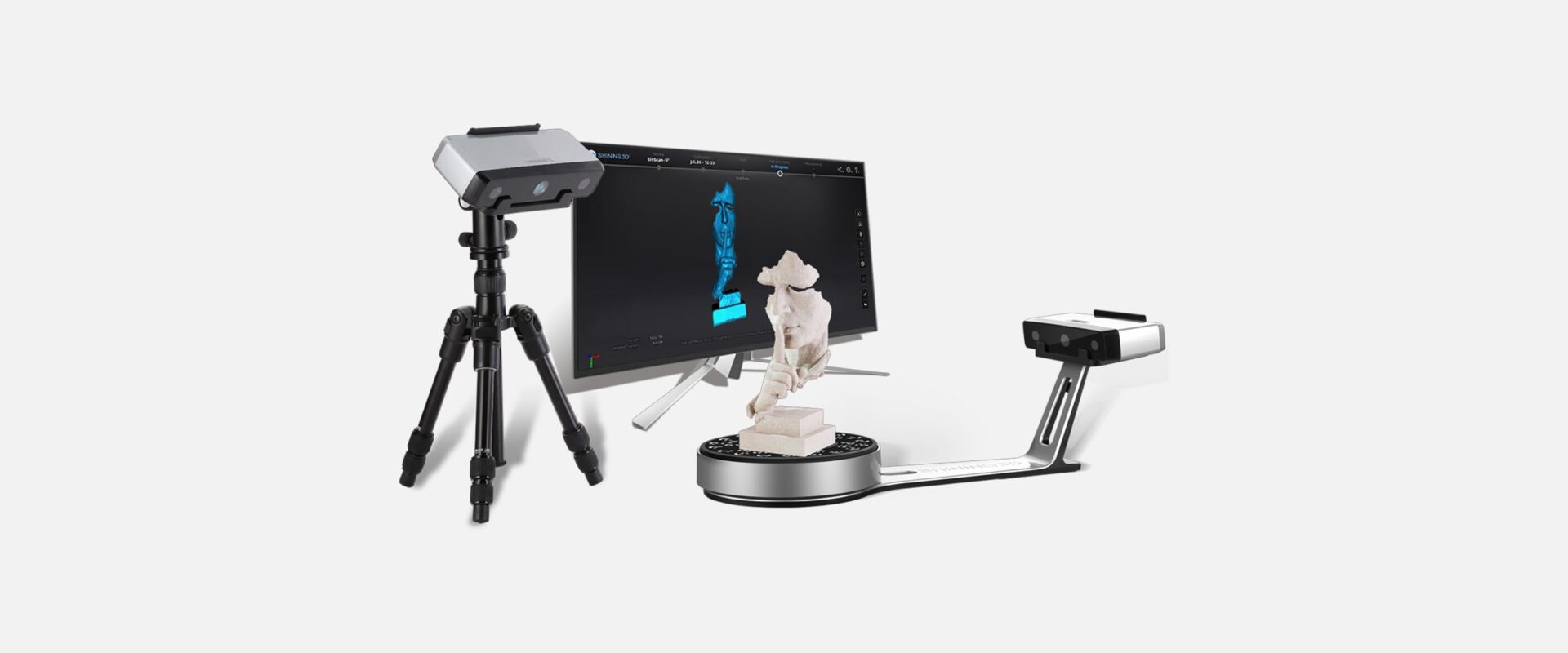 EinScan SP V2 setup with turntable, scanner on tripod, and a display screen showing a detailed 3D scan of a statue.