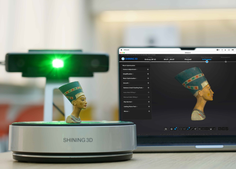 EinScan SP V2 capturing a coloured bust of Nefertiti on the turntable, with the scan software showing the real-time mesh.