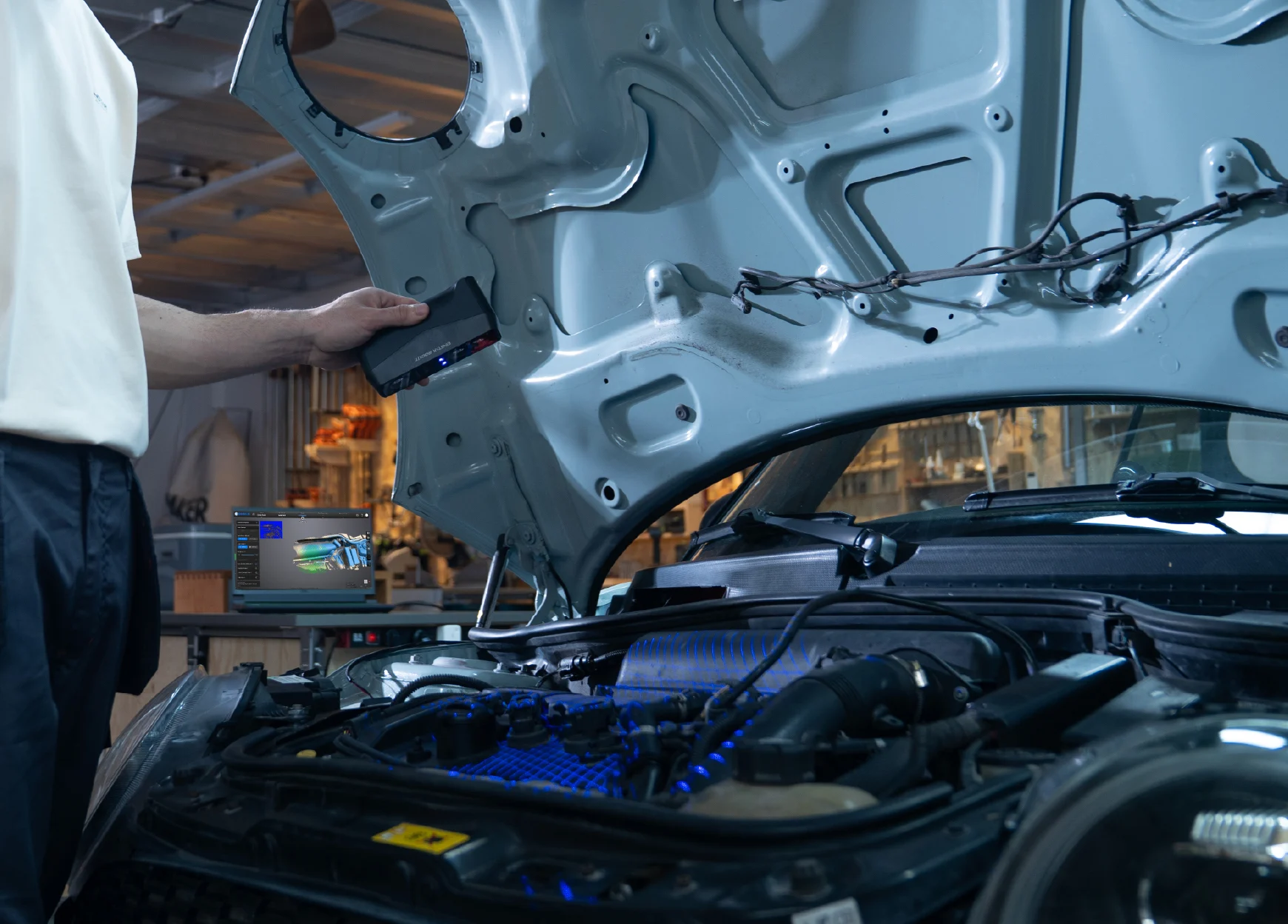 Scanning automotive components with EINSTAR Rockit in marker-free laser mode, capturing detailed surface geometry.