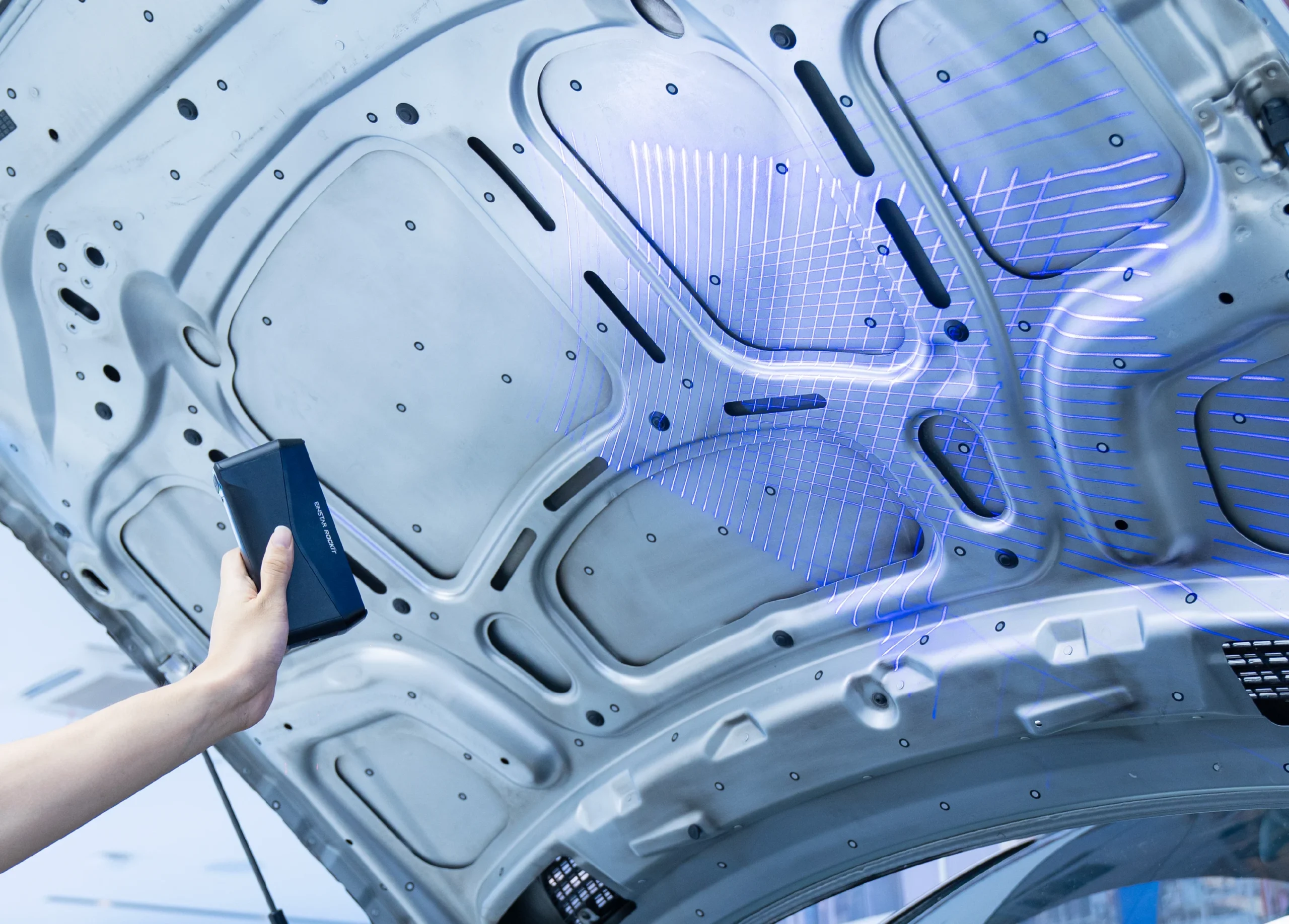 Hand-held close-up of the compact EINSTAR Rockit 3D scanner showing its slim, pocket-sized design.