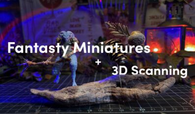 A hand built fantasy miniature made from natural materials displayed on a workbench, with pinecones and acorns in the scene and the text “Fantasy Miniatures + 3D Scanning” overlaid.