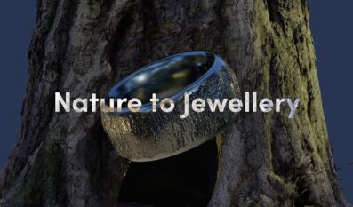 A metallic ring with a textured tree bark surface floats in front of a tree trunk, with the words "Nature to Jewellery" overlaid across the centre.